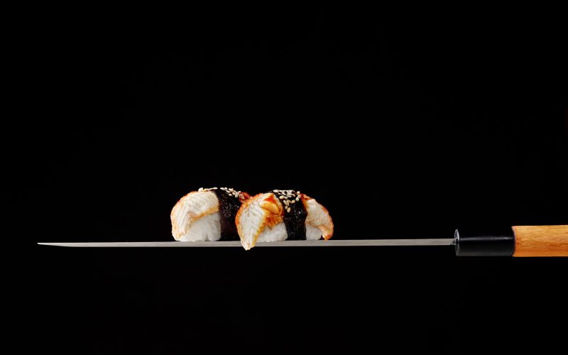 nigiri-sushi-with-eel-served-blade-traditional-japanese-knife-black-background (1)