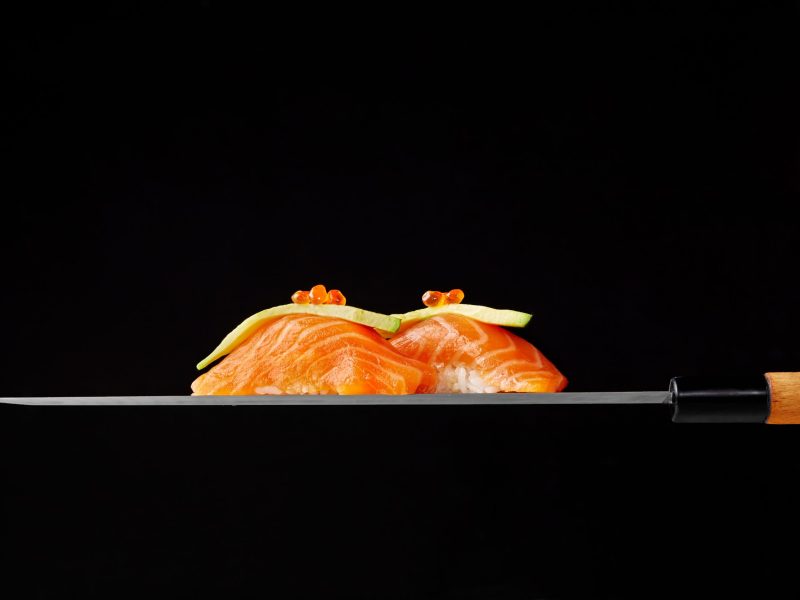 nigiri-sushi-with-raw-salmon-avocado-red-caviar-blade-japanese-knife