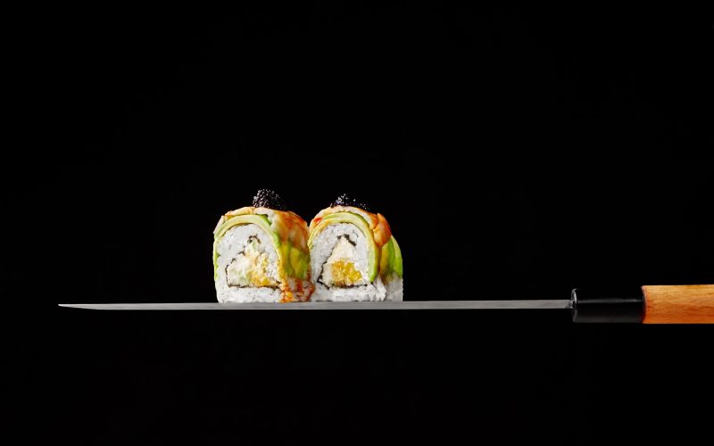 two-uramaki-rolls-with-cream-cheese-mango-avocado-shrimps-blade-japanese-knife-black-ba